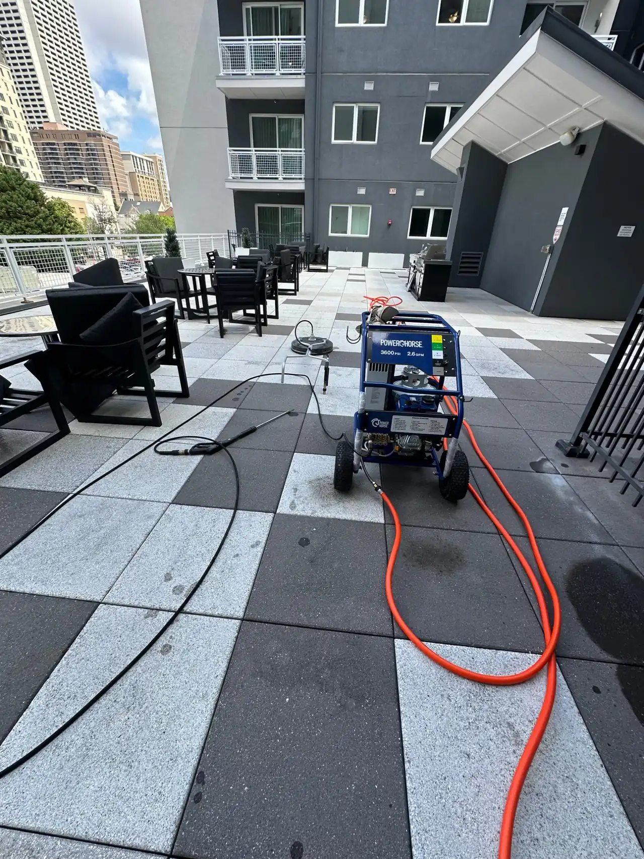 Mr. Brush Cleaning Service pressure washing a rooftop terrace in metro Atlanta